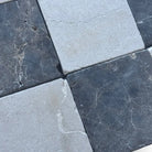 Checkerboard pattern of stone tiles from Checkerboard Crema Marfil Select and Emperador Dark Oro Tumbled Set
