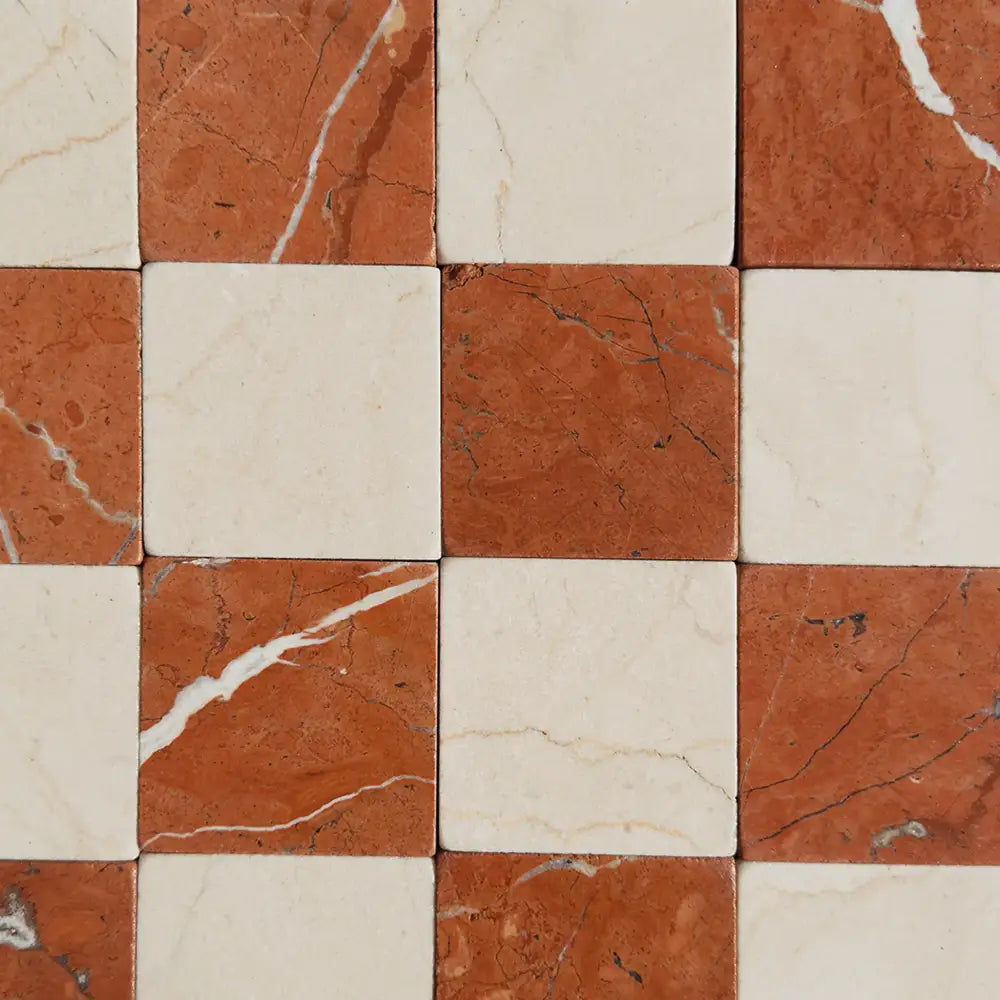 Checkerboard pattern of Crema Marfil and Rojo Alicante marble tiles for elegant flooring