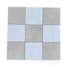 Checkerboard Bianco Dolomite and Crema Marfil 12x12 tiles arranged in checkerboard pattern