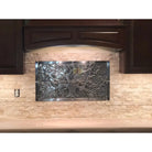 Metal tree-themed backsplash from Checkerboard Emperador Dark Oro Marble and Crema Marfil Select Tumbled 6X6 Set