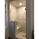 Modern glass shower enclosure with Checkerboard Ming Green and Calacatta Gold Marble tiles
