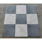Checkerboard pattern of Nero Marquina and Carrara White marble square tiles
