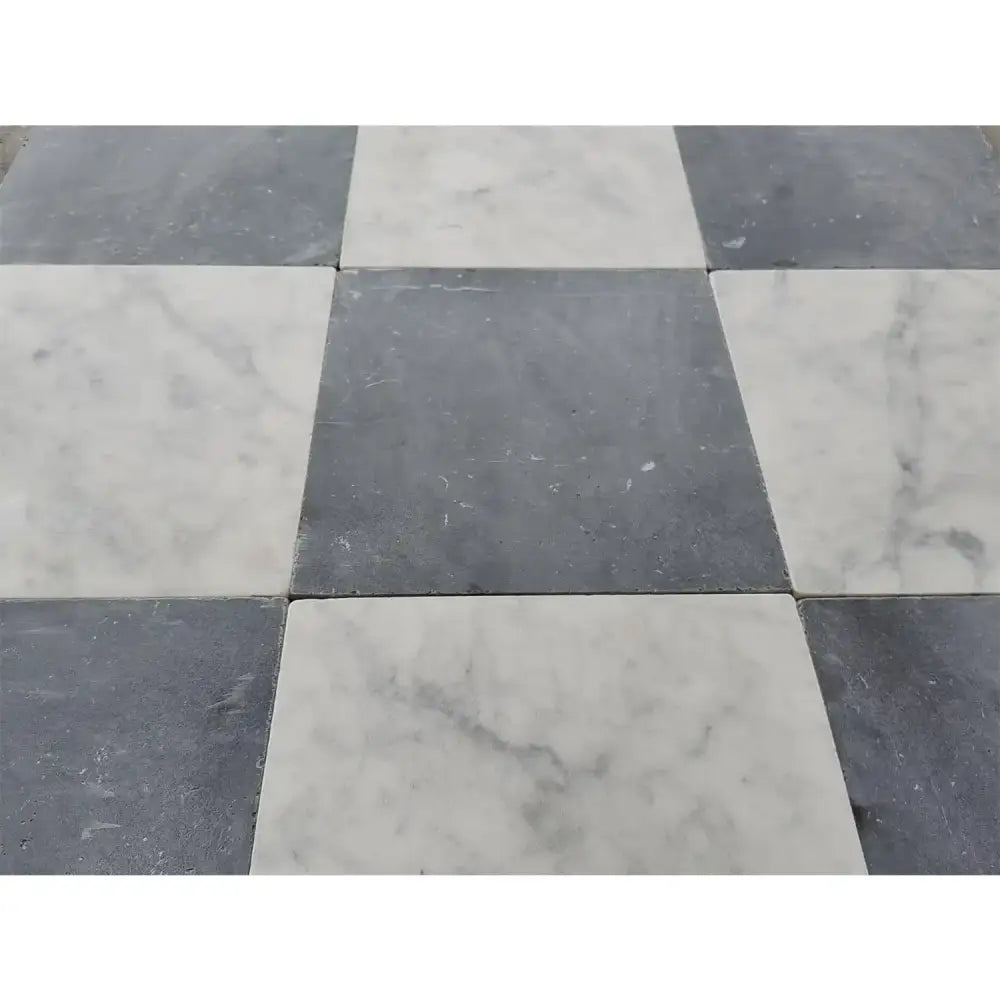 Checkerboard pattern of Nero Marquina and Carrara White Royale marble tiles in 12x12 set