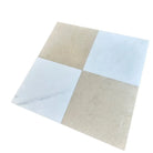 Checkerboard pattern of white and cream square tiles from Aurora and Crema Marfil set