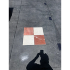 Four 12x12 marble tiles in red-toned Rojo Alicante and cream-colored Crema Marfil