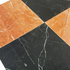 Orange and black marble tile pattern in Checkerboard Rojo Alicante Select and Nero Marquina Prestige 12X12 Set