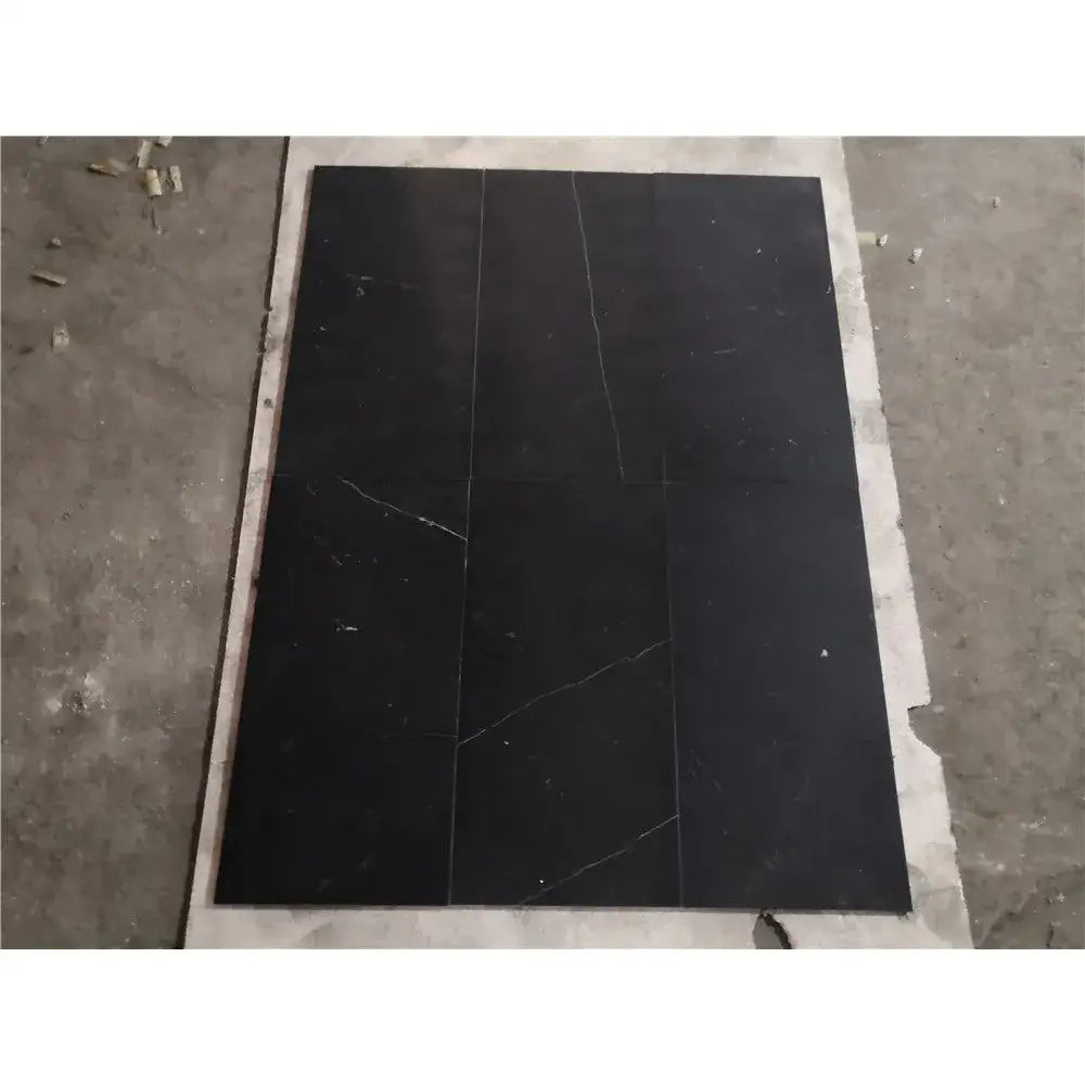 Black marble tiles with white veining from Checkerboard Rosso Levanto and Nero Marquina 12X12 Set