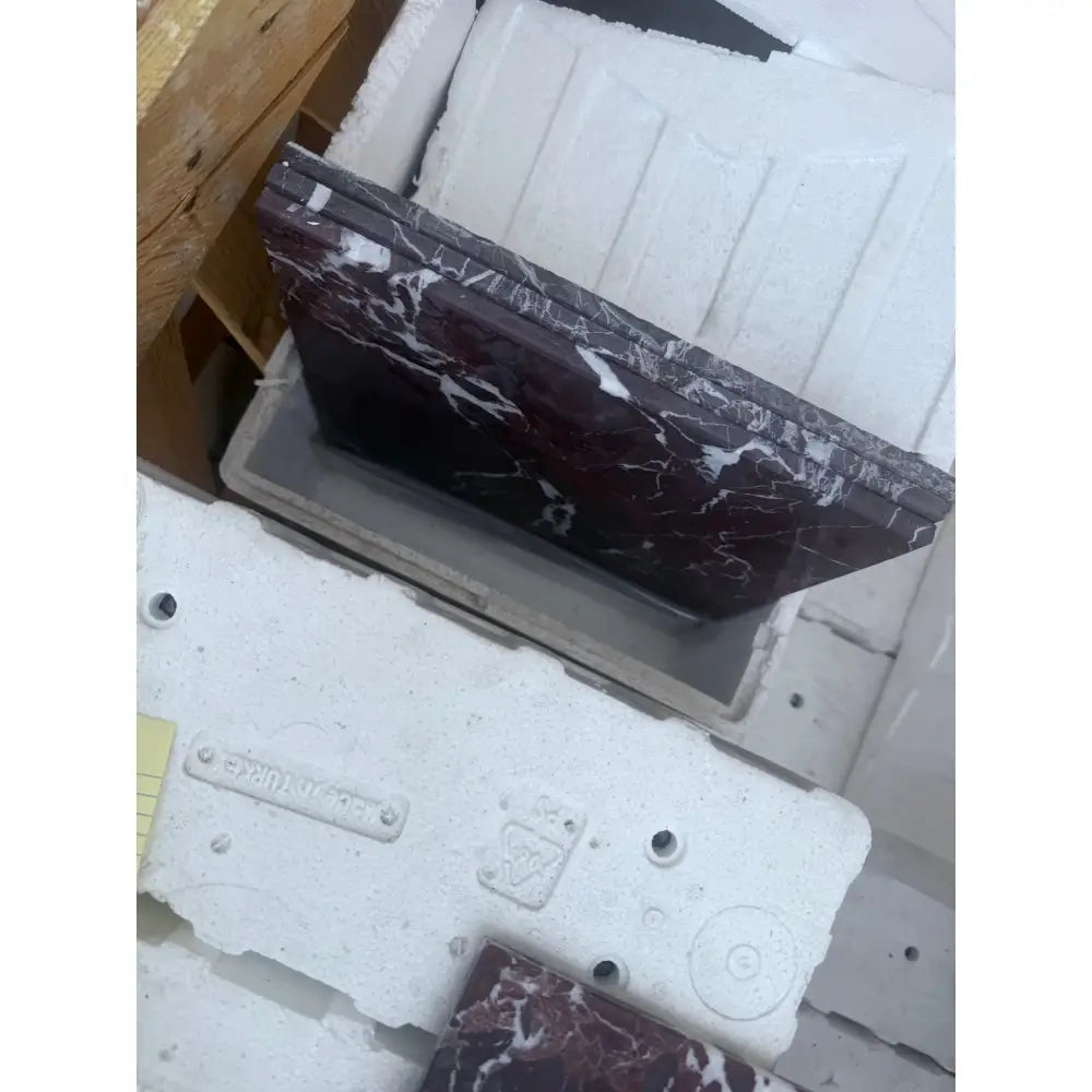 Maroon marble countertop with white veining from Checkerboard Rosso Levanto and Crema Marfil 12X12 Set
