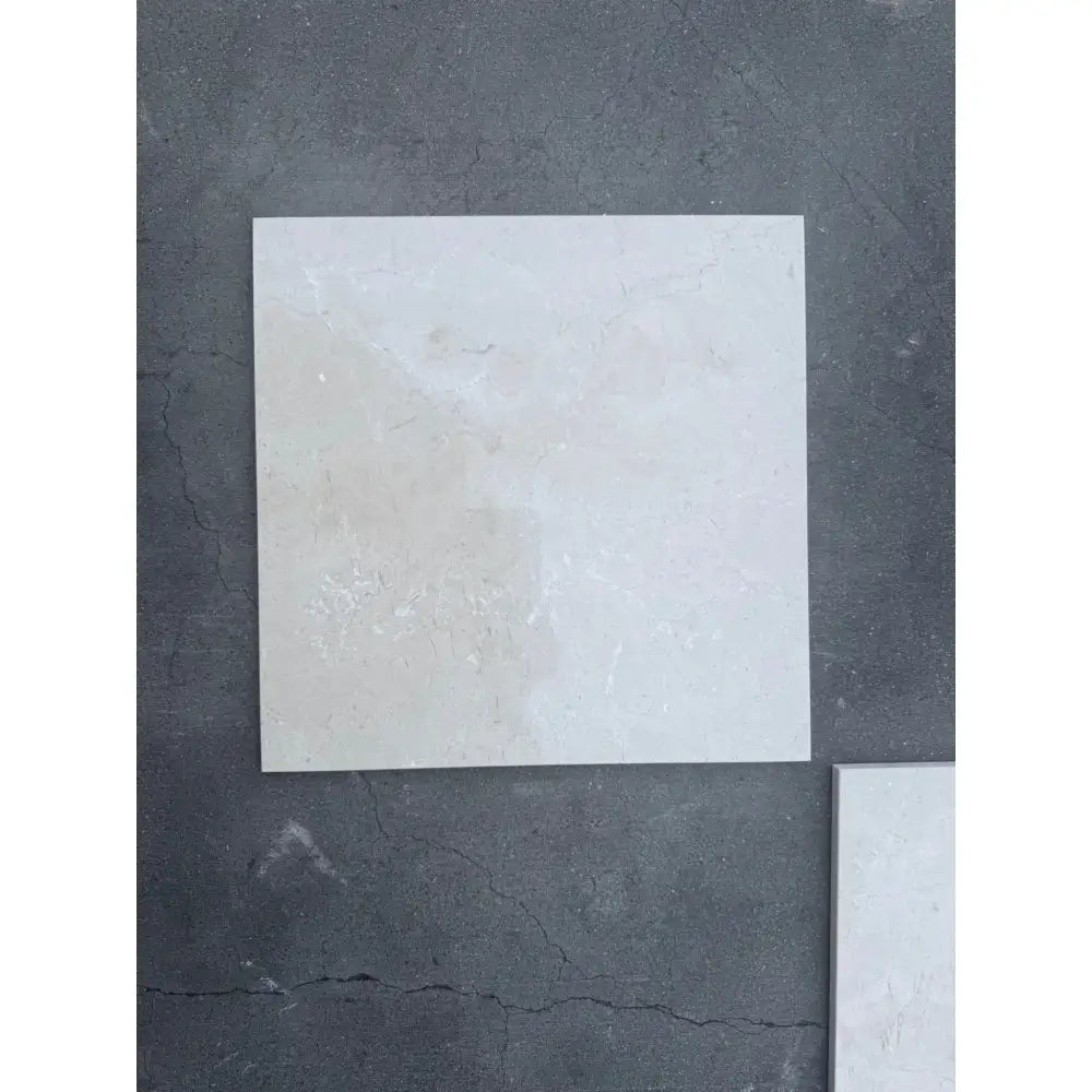 Off-white square tile with subtle marbling for Checkerboard Rosso Levanto and Crema Marfil set