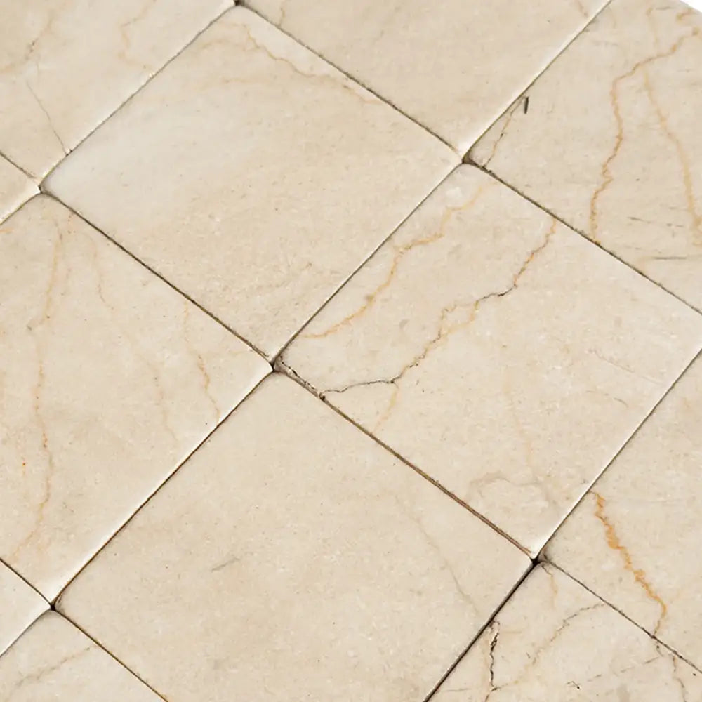 Tiled marble floor in Crema Marfil Select 3X3 Tumbled pattern