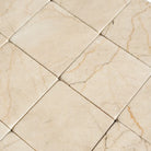 Tiled marble floor in Crema Marfil Select 3X3 Tumbled pattern