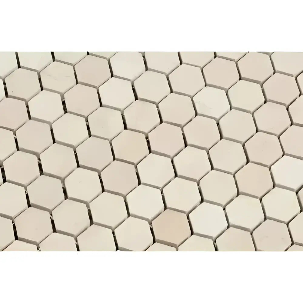 Beige hexagonal tile pattern from Crema Marfil Select Marble 1 inch Mosaic Tile