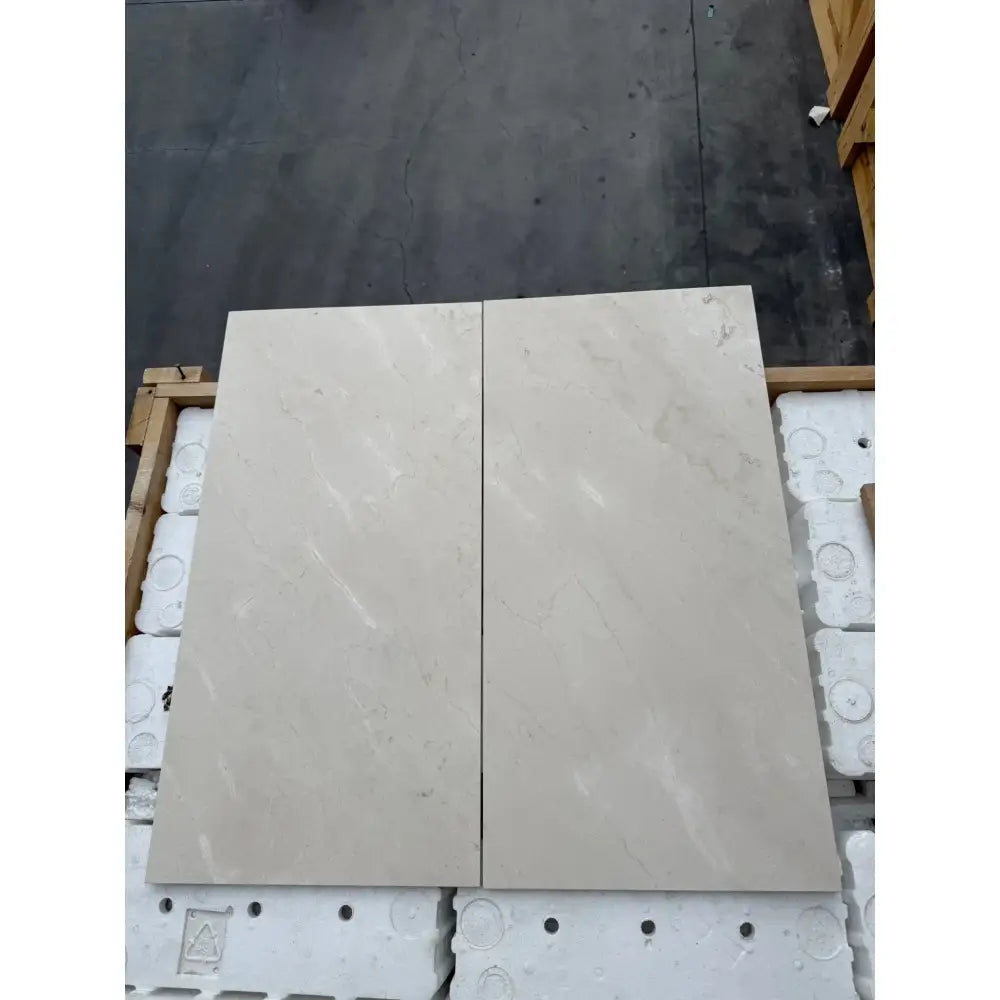 Two rectangular Crema Marfil Select Marble slabs in light color with polished or honed finish