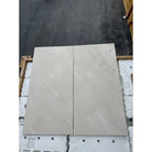 Two rectangular Crema Marfil Select Marble slabs in light color with polished or honed finish