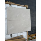 Two rectangular light-colored Crema Marfil Select Marble tiles for flooring or wall use