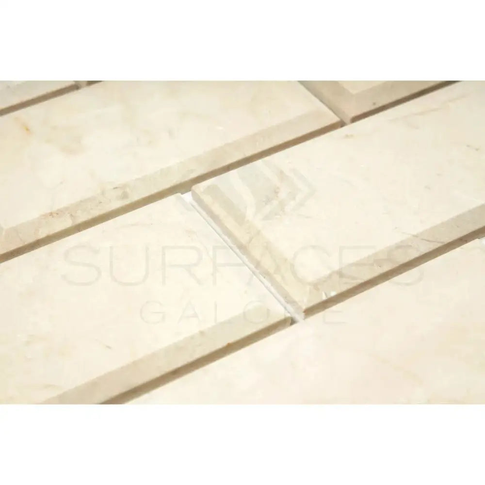Beveled cream-colored tiles from Crema Marfil Select Marble 3X6 product display
