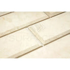 Beveled cream-colored tiles from Crema Marfil Select Marble 3X6 product display
