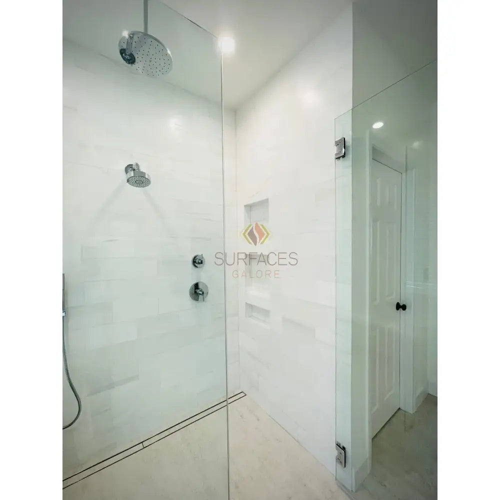 Modern glass shower enclosure featuring Dolomite Prestige White Dolomite Hexagon Mosaic