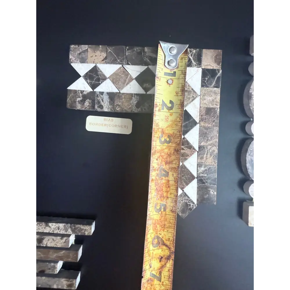 Marble mosaic tile sample featuring Emperador Dark Oro Marble 2X12 bias border and Crema Marfil dots