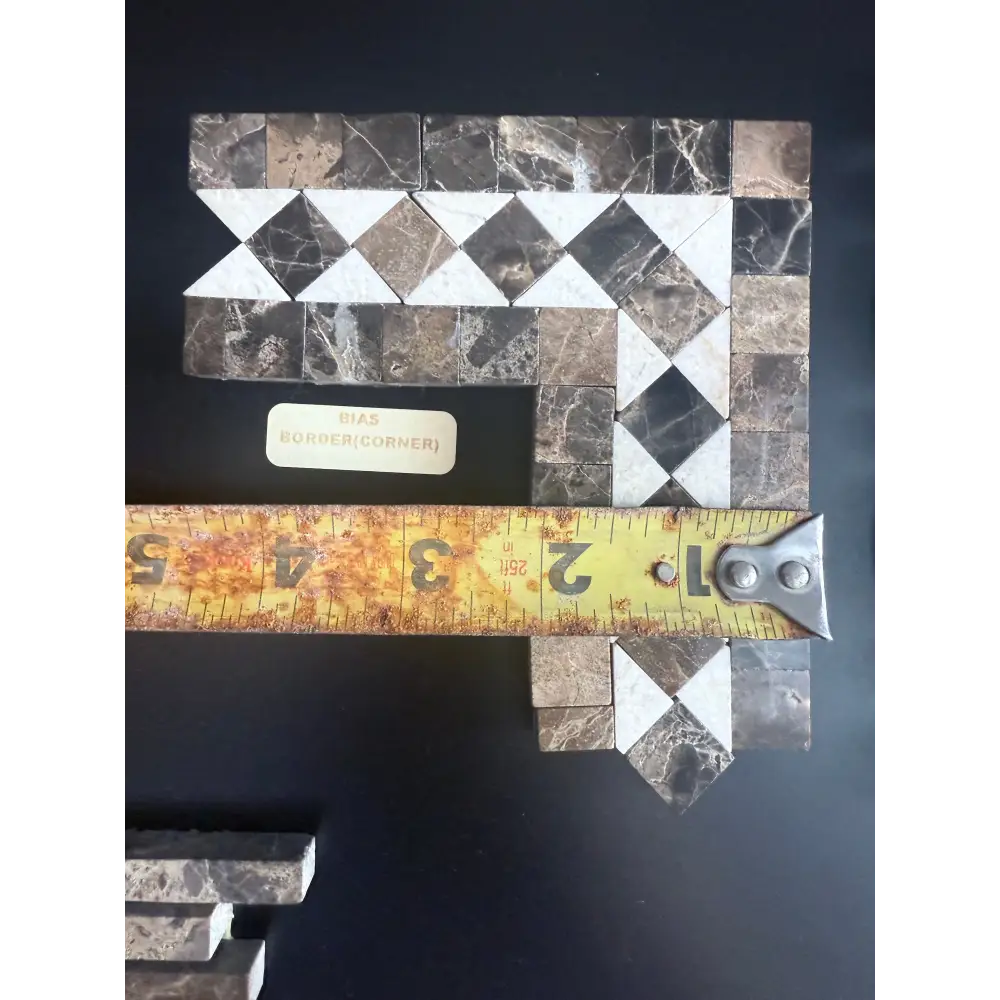Mosaic tile corner piece from Emperador Dark Oro Marble with Crema Marfil dots