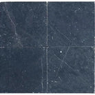 Four dark Nero Marquina Marble 12X12 Tumbled tiles showcasing elegant design