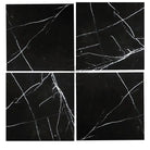 Four black marble tiles with white veining from Nero Marquina Black Marble collection
