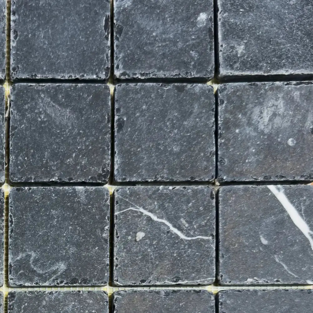 Dark gray square stone tiles from Nero Marquina Prestige Marble 2X2 Tumbled collection