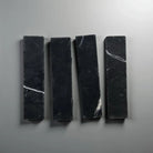 Four black Nero Marquina Prestige Marble rectangles in a mosaic pattern