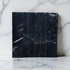 Black Nero Marquina marble tiles with striking white veining for elegant wall or floor design