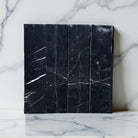 Black Nero Marquina marble tiles with striking white veining for elegant flooring