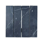 Four black Nero Marquina Prestige marble tiles in a 3x12 inch field tile layout