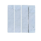 Four marble tiles from Oriental White Aurora 3x12 field tile collection