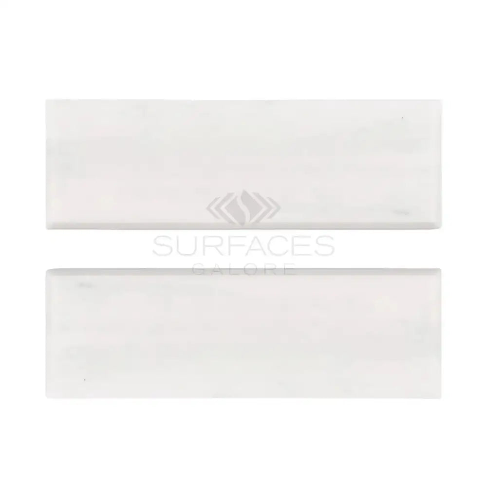 Two white rectangular tiles from Oriental White Aurora Asian Statuary Marble collection