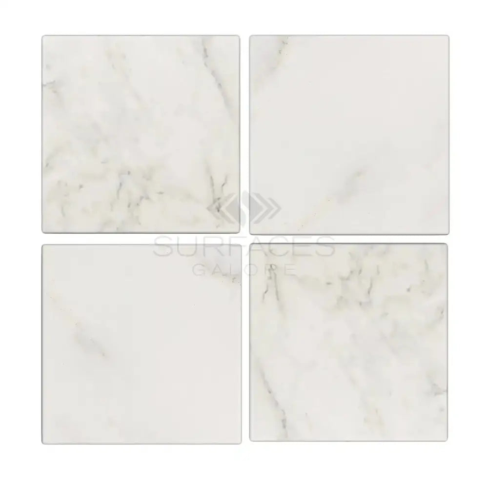 Four square Oriental White Aurora Asian Statuary Marble tiles on display
