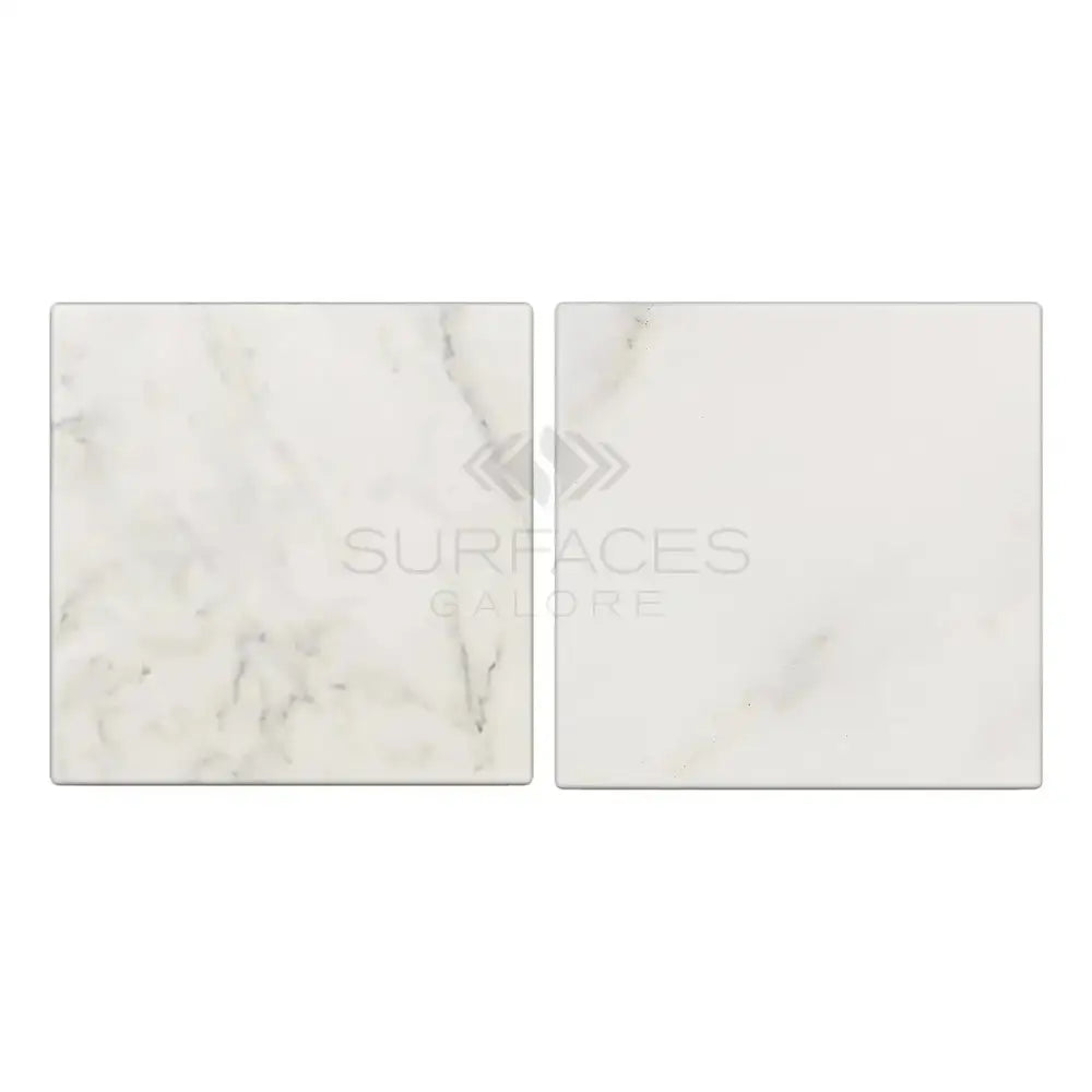 Two square Oriental White Aurora marble tiles with tumbled finish for flooring or wall use