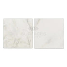 Two square Oriental White Aurora marble tiles with tumbled finish for flooring or wall use