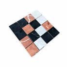 Checkerboard pattern of Rojo Alicante Select, Carrara White, and Nero Marquina marble tiles