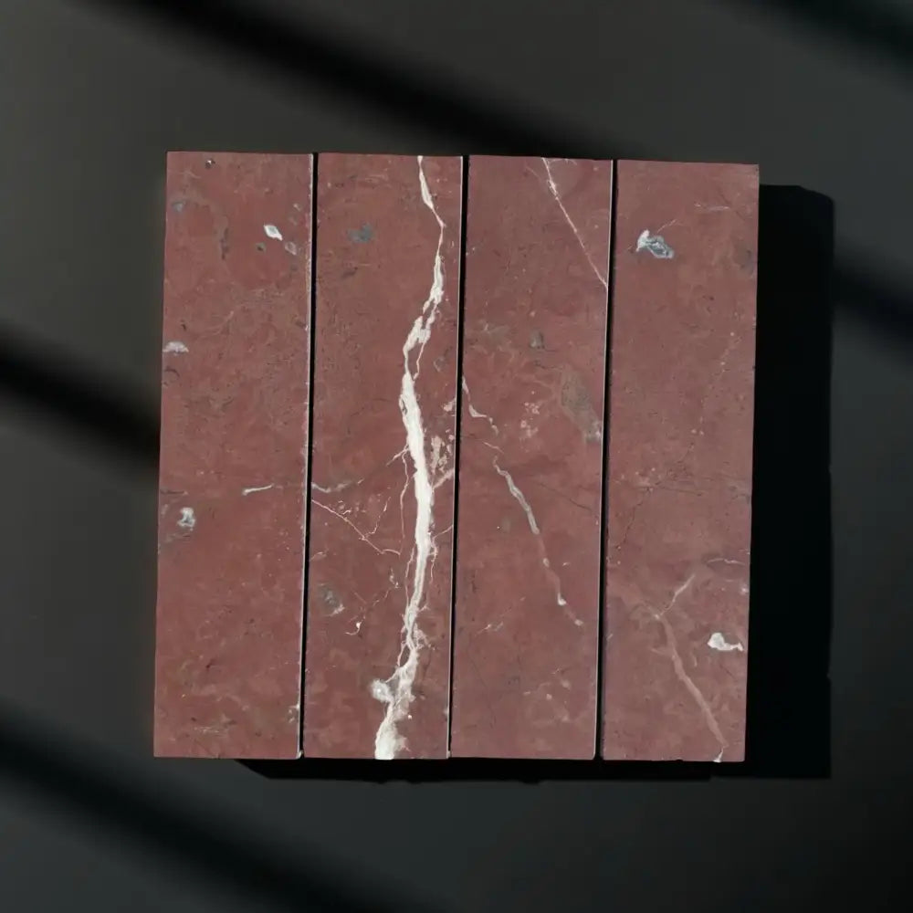 Red marble tile arrangement showcasing Rojo Alicante Select Marble 3x12 Field Tile