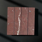 Red marble tile arrangement showcasing Rojo Alicante Select Marble 3x12 Field Tile