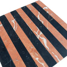 Alternating black and orange striped marble tile in Rojo Alicante Select and Nero Marquina Prestige Mosaic