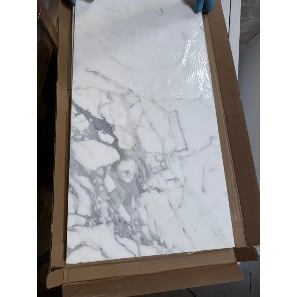Marble-patterned white tile in cardboard packaging for Statuary Statuario White 12x12 Italian Marble