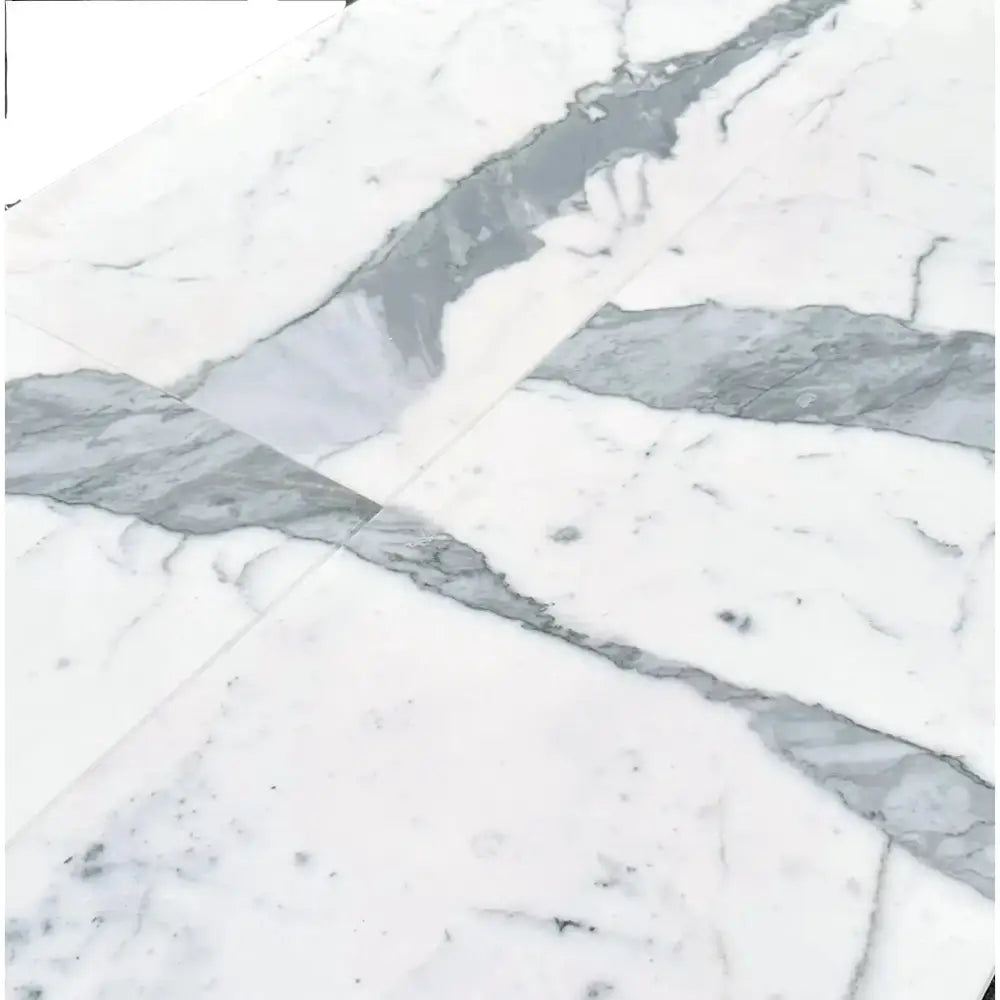 White marble surface with gray veining from Statuary Statuario White 12x24 Italian Marble