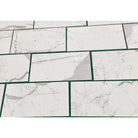White marble-patterned tiles with green grout from Statuary Statuario White 4X12 Italian Marble
