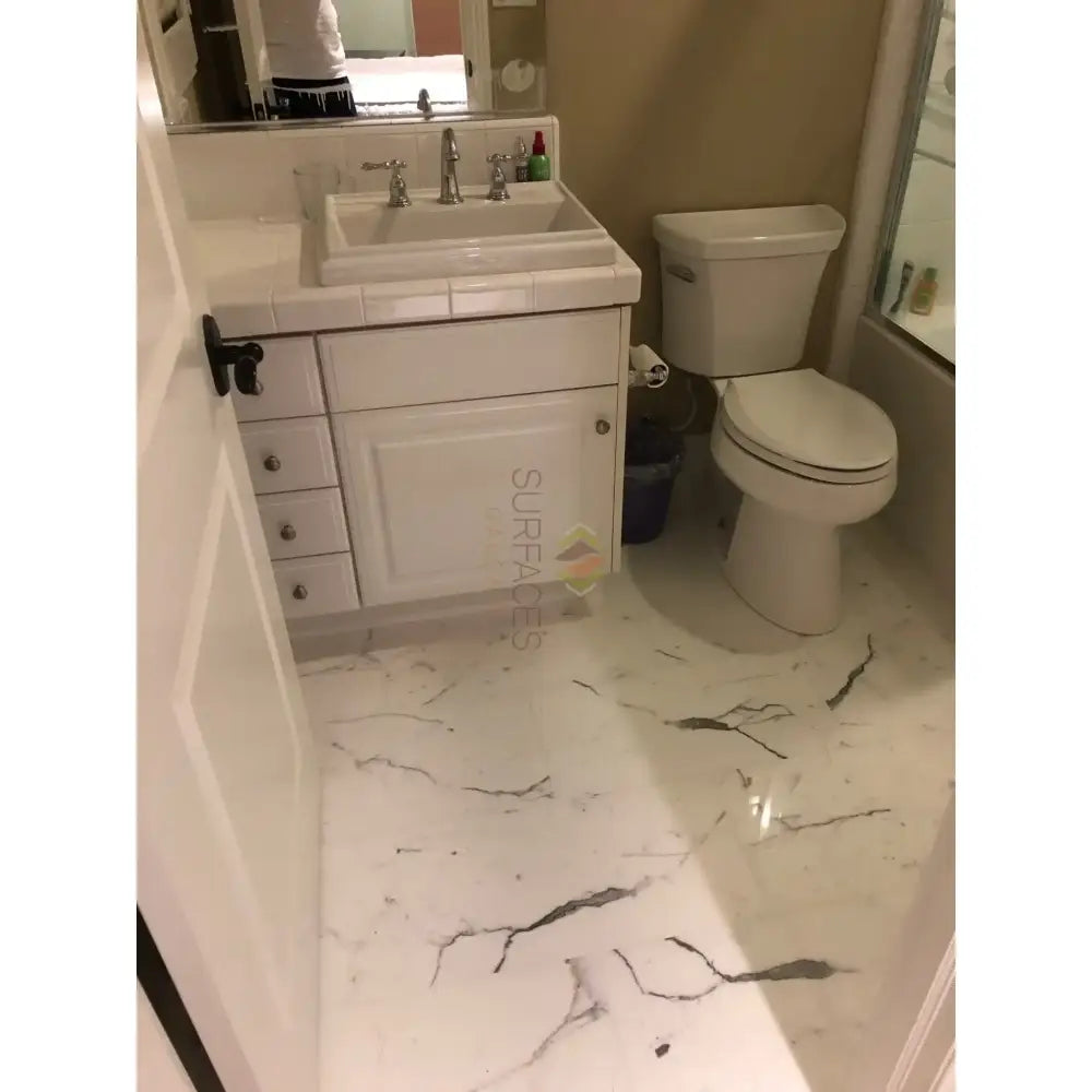 White bathroom with marble floor featuring Statuary Statuario White 4X12 Italian Marble