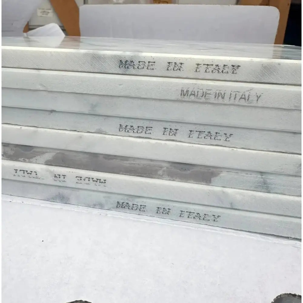 Stacked Statuary Statuario White 4X12 Italian Marble Tiles with MADE IN ITALY inscription