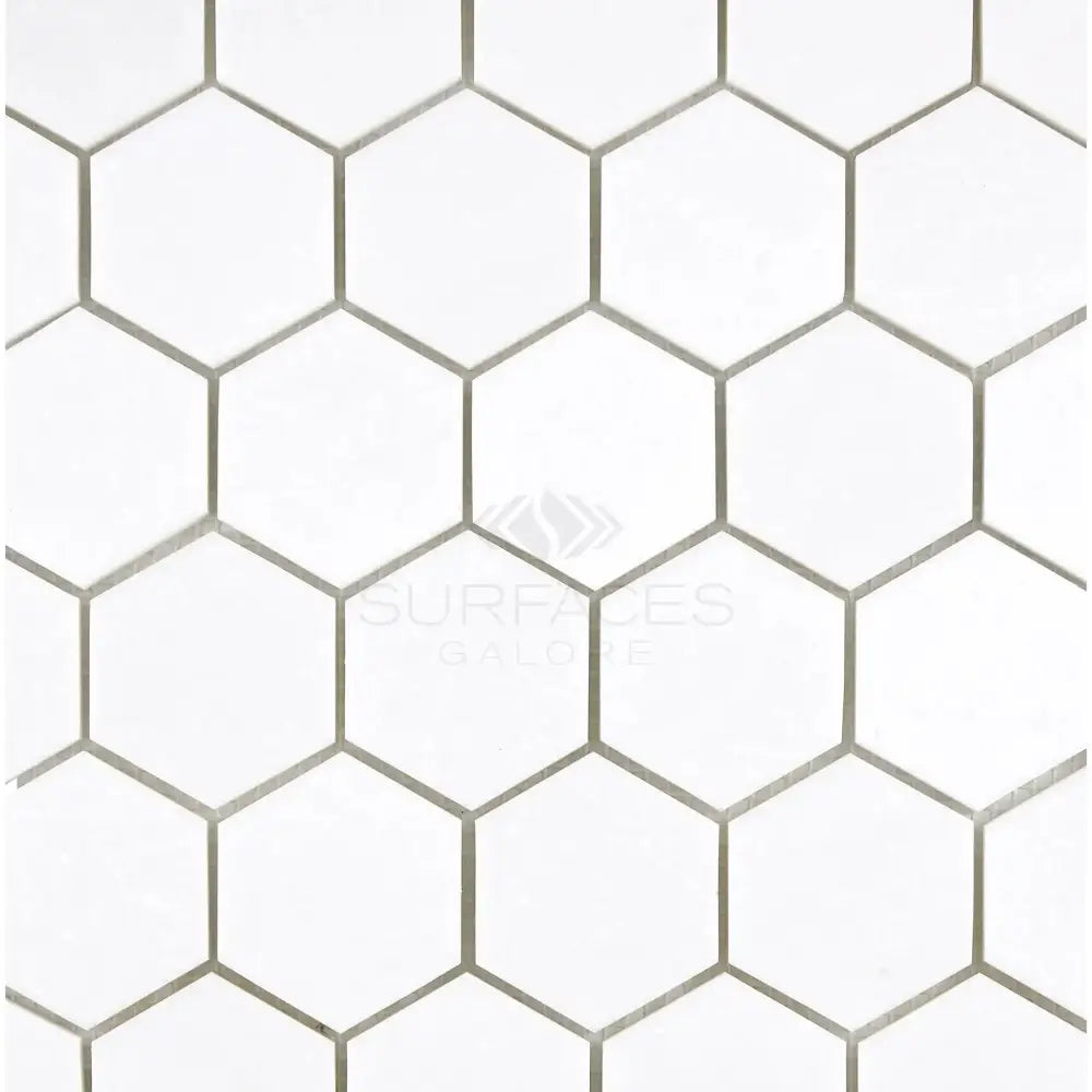 White hexagonal tile pattern from Thassos Supreme 2 Inch Hexagon Mosaic Marble