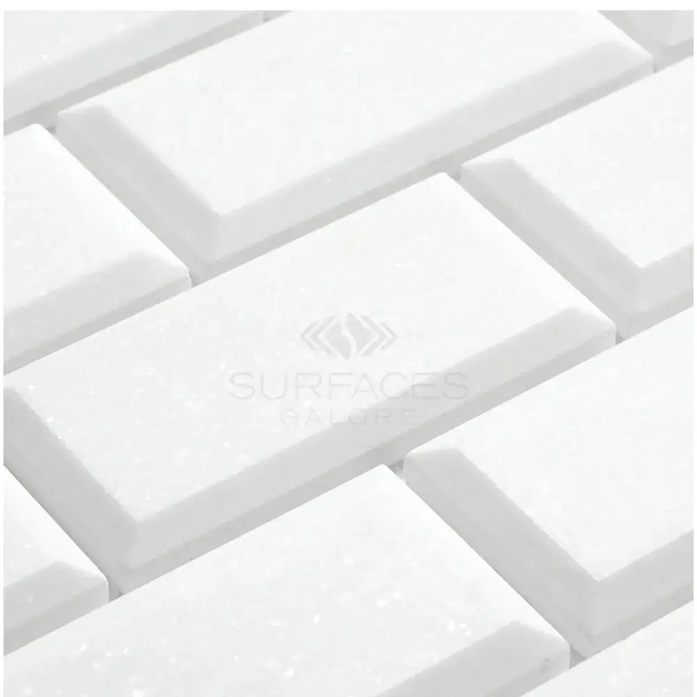 White rectangular beveled marble tiles from Thassos Supreme 2X4 Deep-Beveled Brick Mosaic collection