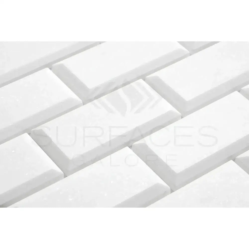 White beveled subway tiles from Thassos Supreme 2X4 Deep-Beveled Brick Mosaic Marble