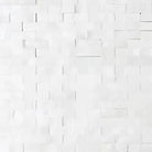 White brick wall featuring Thassos Supreme 3/8X1 Mini-Brick Mosaic Marble Split-Faced