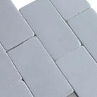Gray rectangular Thassos Supreme 3x6 Marble Tumbled tiles in herringbone pattern